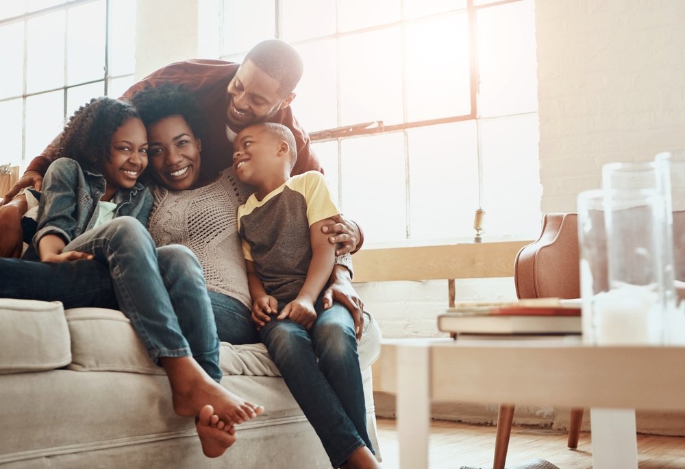 Black family reviewing health insurance documents and medical bills